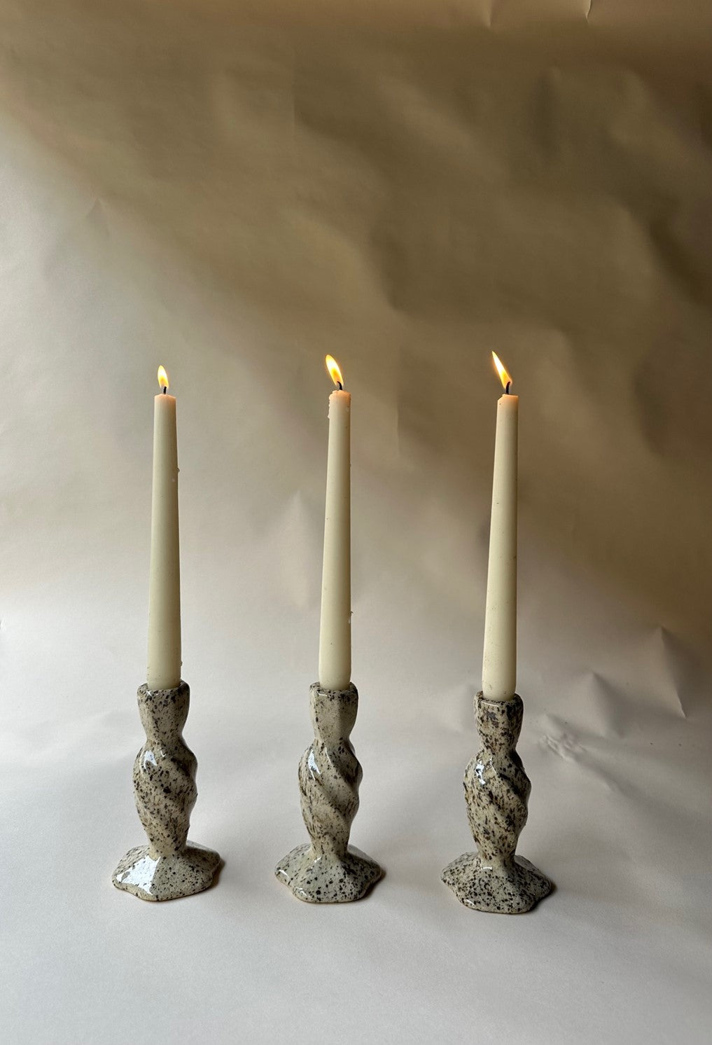 Cream specked pottery candlestick