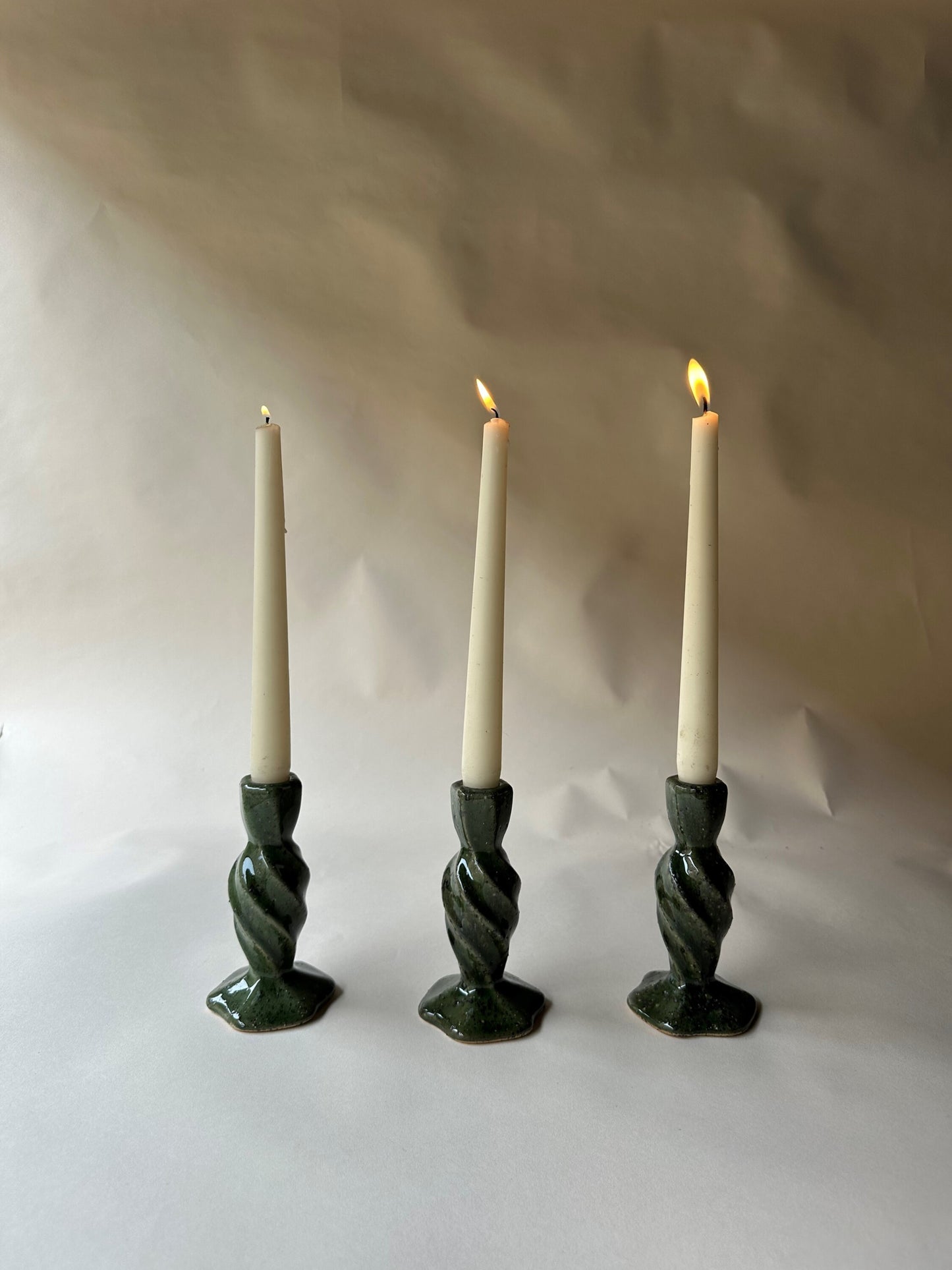 Green specked pottery candlesticks