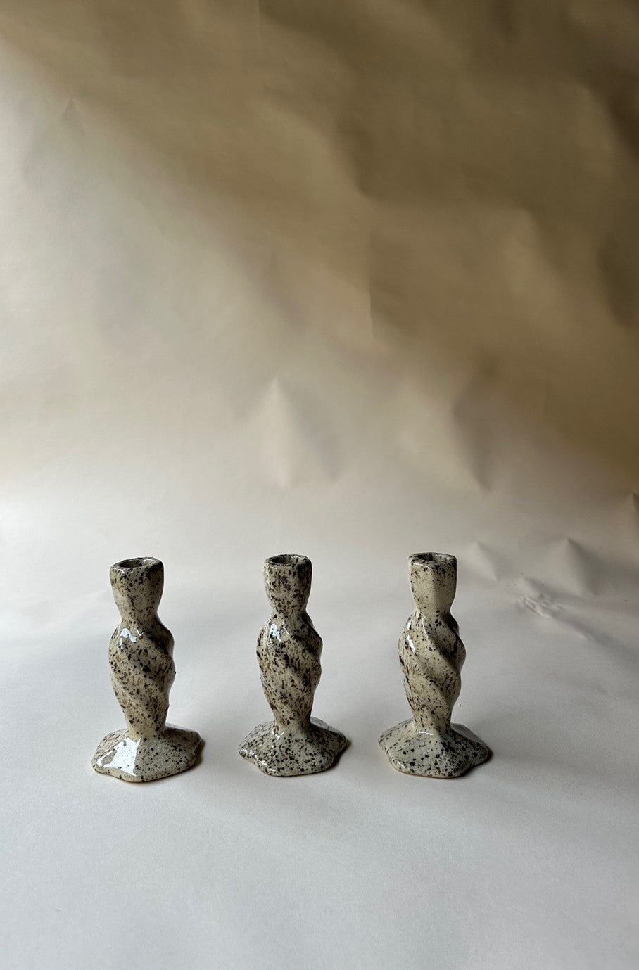 Cream specked pottery candlestick