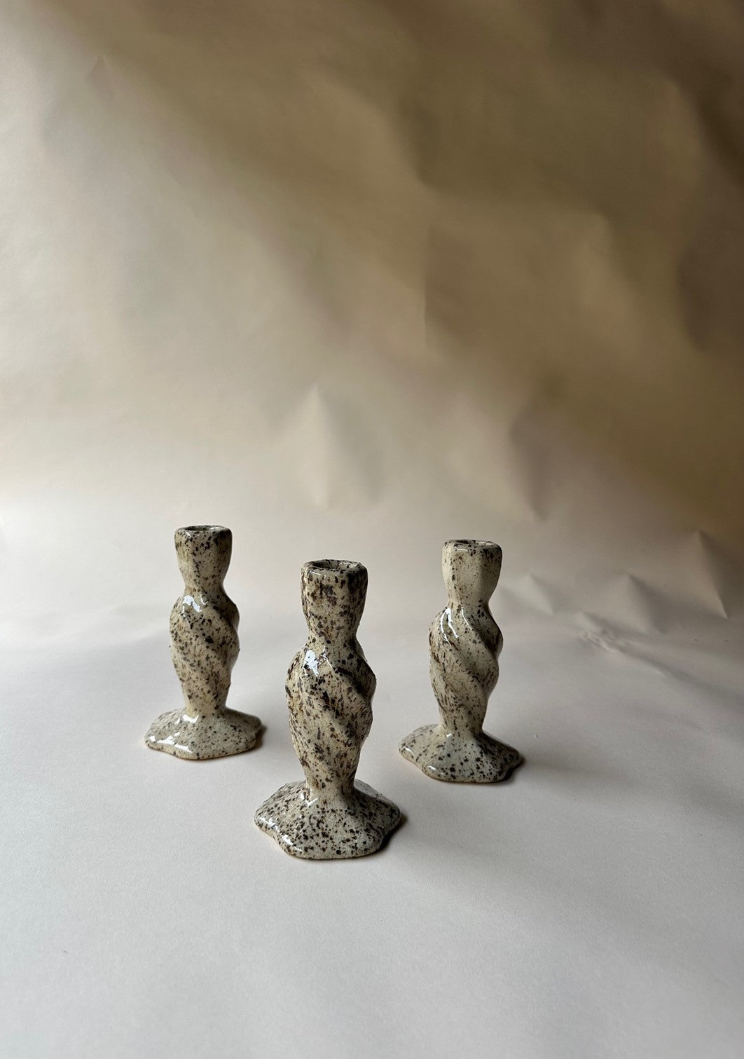 Cream specked pottery candlestick