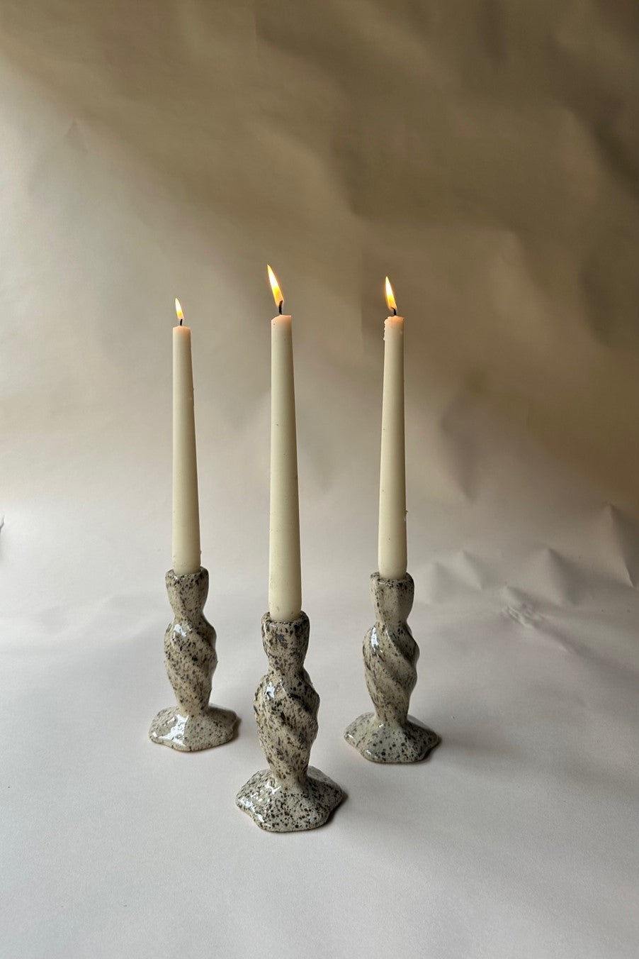 Cream specked pottery candlestick