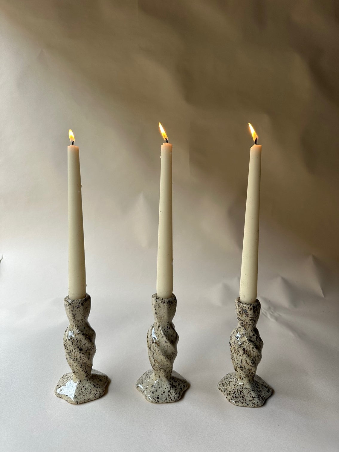 Cream specked pottery candlestick