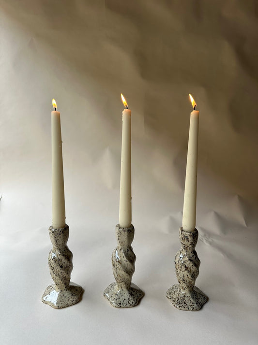 Cream specked pottery candlestick