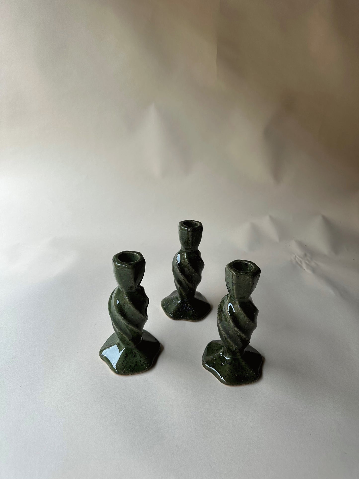 Green specked pottery candlesticks