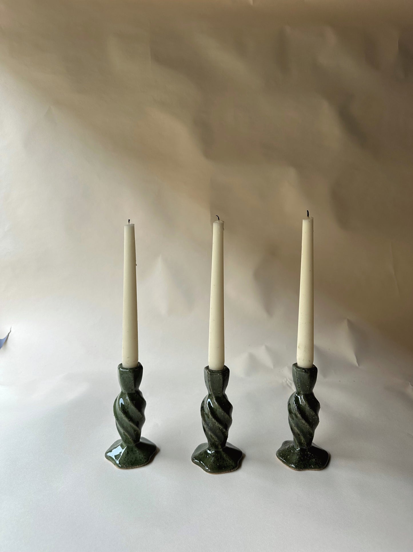 Green specked pottery candlesticks