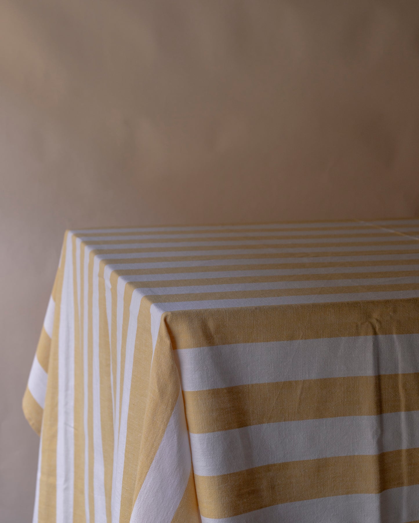 Striped pale yellow table cloth
