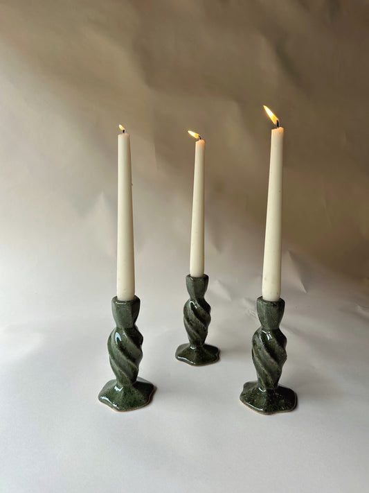 Green specked pottery candlesticks